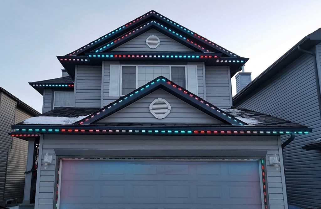 house with outdoor permanent lights blue red